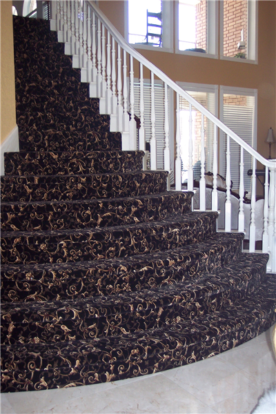 Woven Patterned Carpet on Stairs. They are curved and bow out like a wedding cake.
