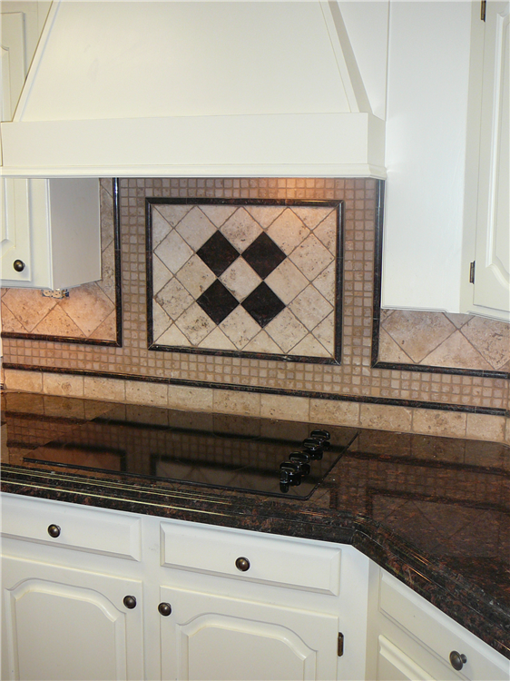 After client remodeled her floors with us and updated her paints and texture, she asked to make a special Granite with laminated edging. It is a demi over ogee edge. The granite pulls in the coral colors (her favorite!) and coordinates nicely in person! Tumbled stone and granite backsplash. *We planned several layouts on the computer for her. This was her top choice for simplicity